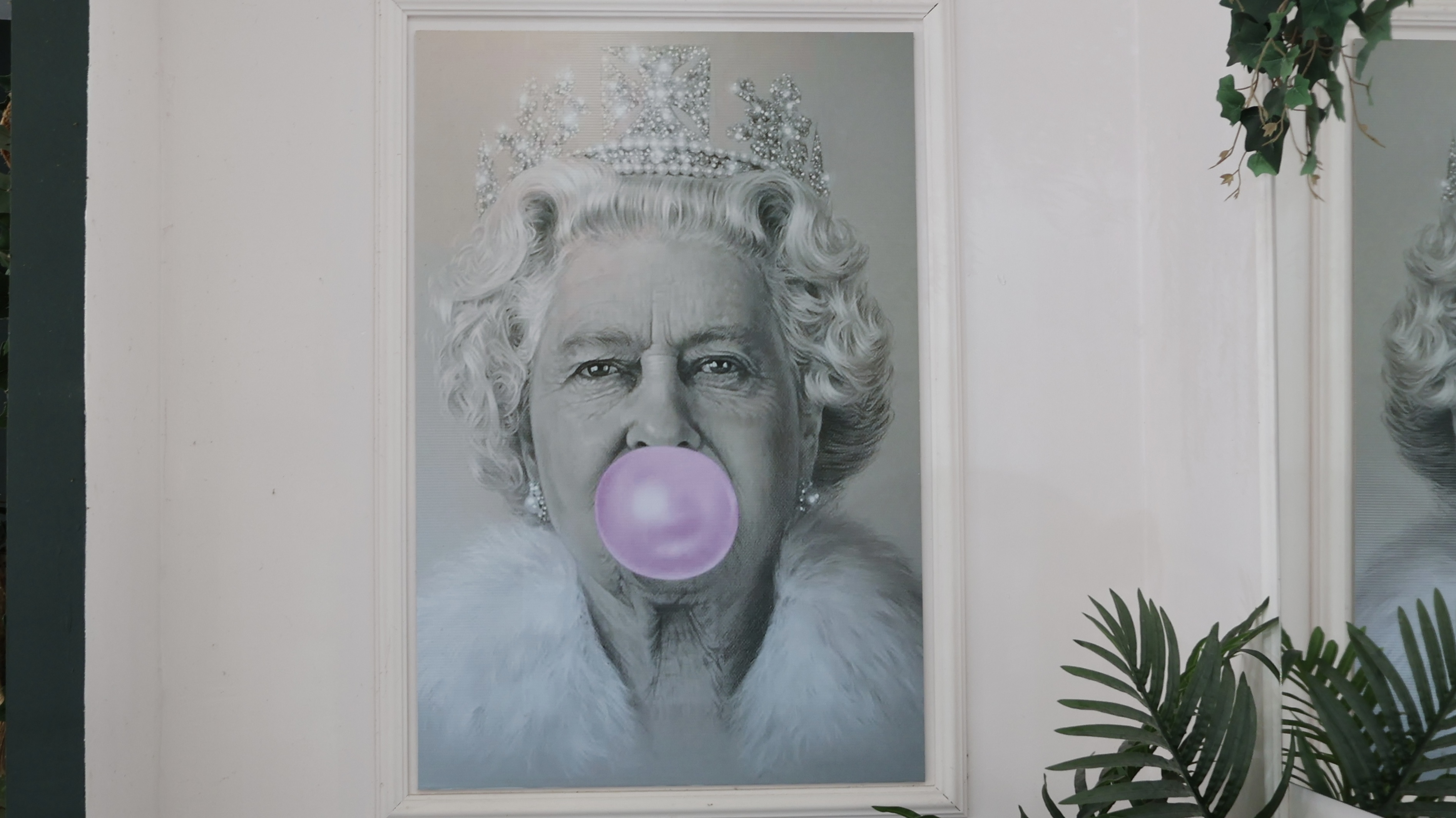Queen of England blowing a bubble gum
